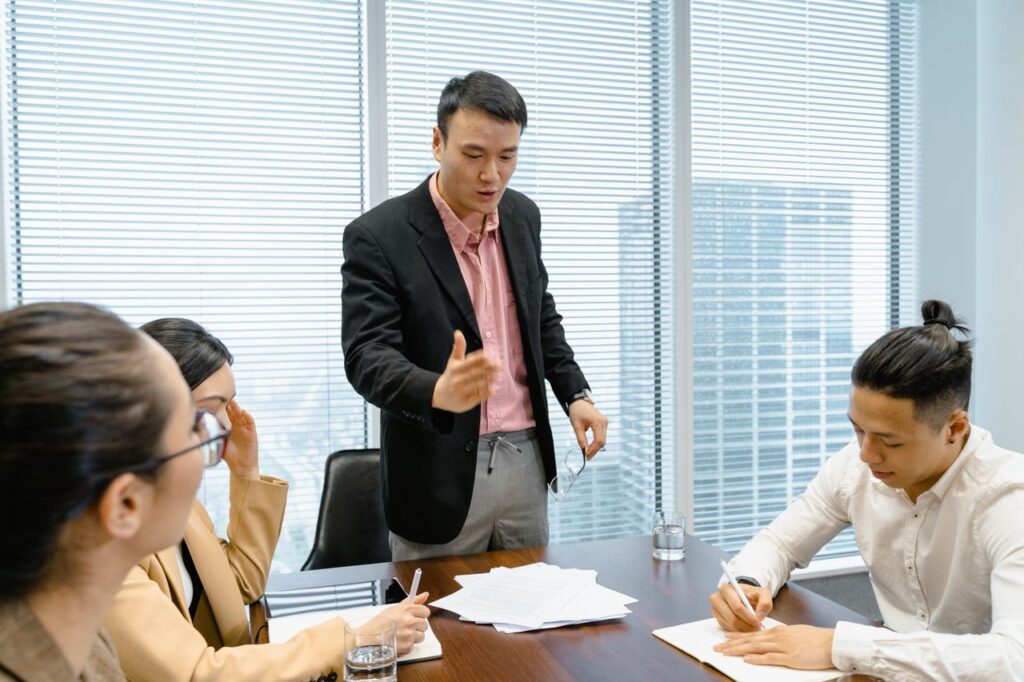 Business professionals discussing strategy during a corporate meeting in a modern boardroom.